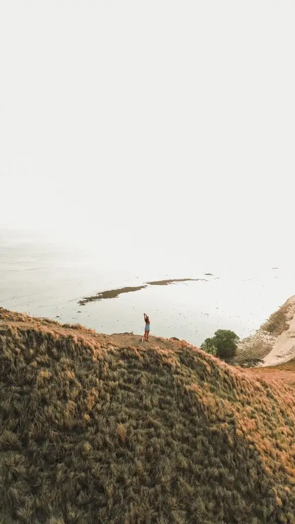 A landscape photo of our guest on top of the hill of Kenawa Island, Lombok