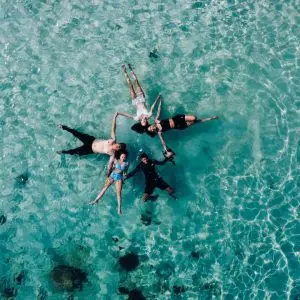 DRONE PHOTO OF A GROUP FLOATING AT PINK BEACH KOMODO NATIONAL PARK
